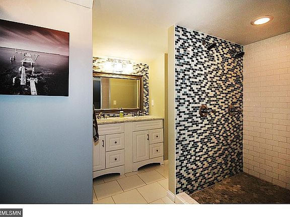 Master bath with double vanity, shell shower, built-in display shelving