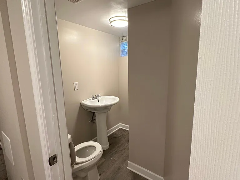 Looking into basement powder room from utility room