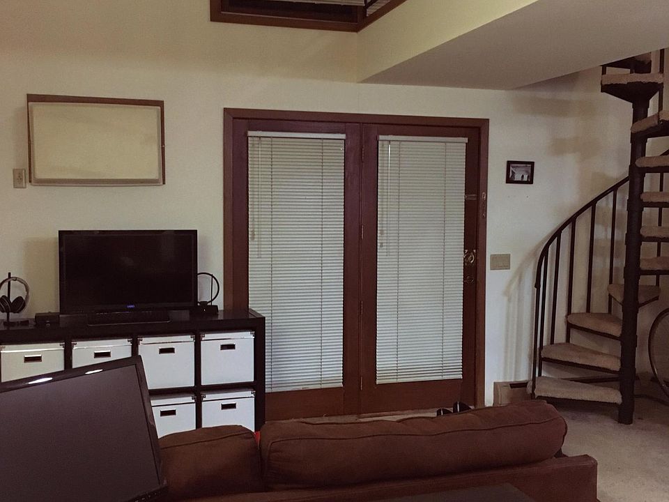 living room, lofted ceilings, large windows, spiral staircas