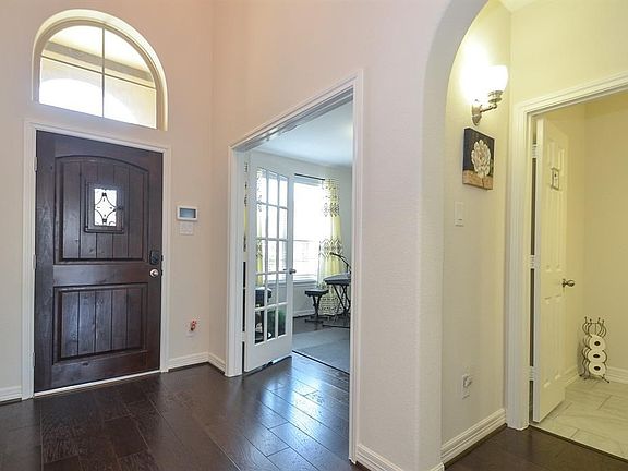 Beautiful wood paneled door with iron grate window.