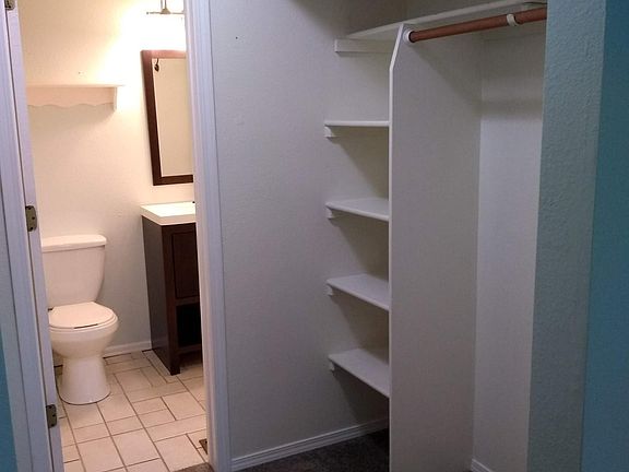 Main closet leading to upstairs bathroom.