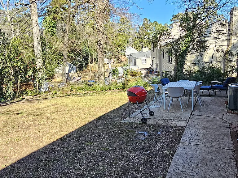 Patio with fully fenced backyard