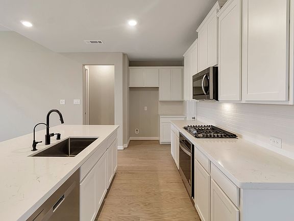 Kitchen featuring plenty of counterspace and cabinetry