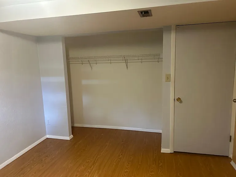 Basement bedroom has closet and one door to the basement living area and one door to the laundry room