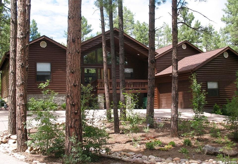Home is located on a 1/2 acre, heavily wooded lot with ponderosa pine. 2-car garage. Easy access semi-circular cement driveway.