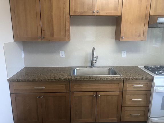 remodeled kitchen with granite countertops and seamless, cabinet height, backsplash (easy to clean)