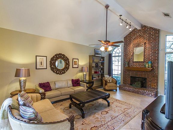 Another view of the Living room with brick fireplace & accent lighting