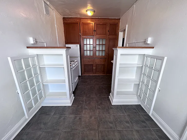 Showcasing an impressive wall of built-in cabinetry, offering both charm and exceptional storage, as well as, additional built ins in the dining space.