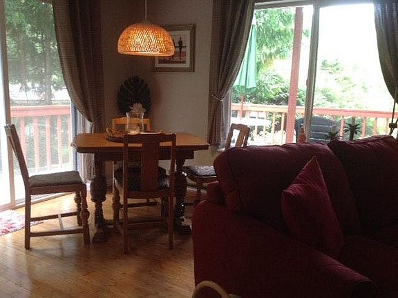 Dining, plus kitchen counter seating, sliding glass door to access deck.