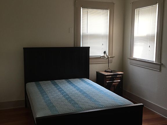 Bedroom with bed frame and walk in closet (not shown)