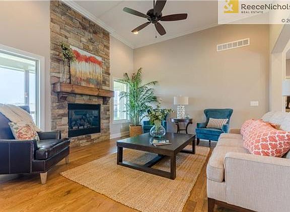 Great room has wood floors, stone floor to ceiling gas fireplace