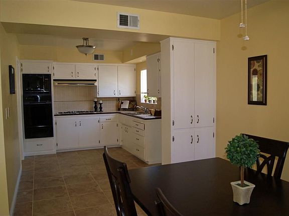 Kitchen and Dining Combo with New Tile and Lighting Fixtures.