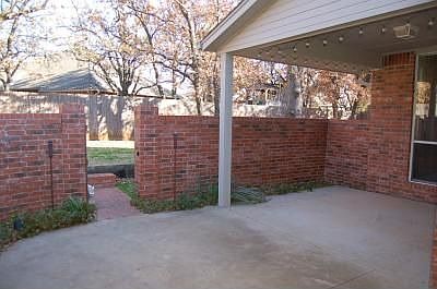 Huge covered patio with brick wall for privacy