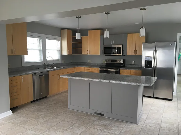 Huge kitchen with stainless steel appliances.