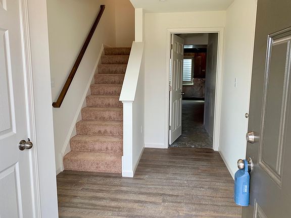 Into the house (stairs to the main floor & door to the unfinished storage area)
