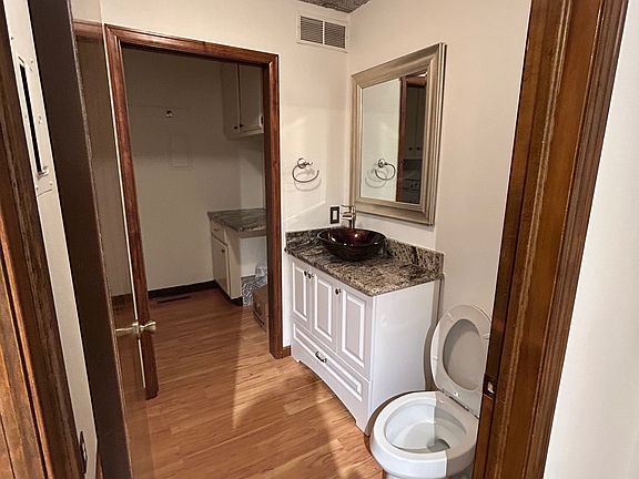 Updated half bath which leads into the laundry room