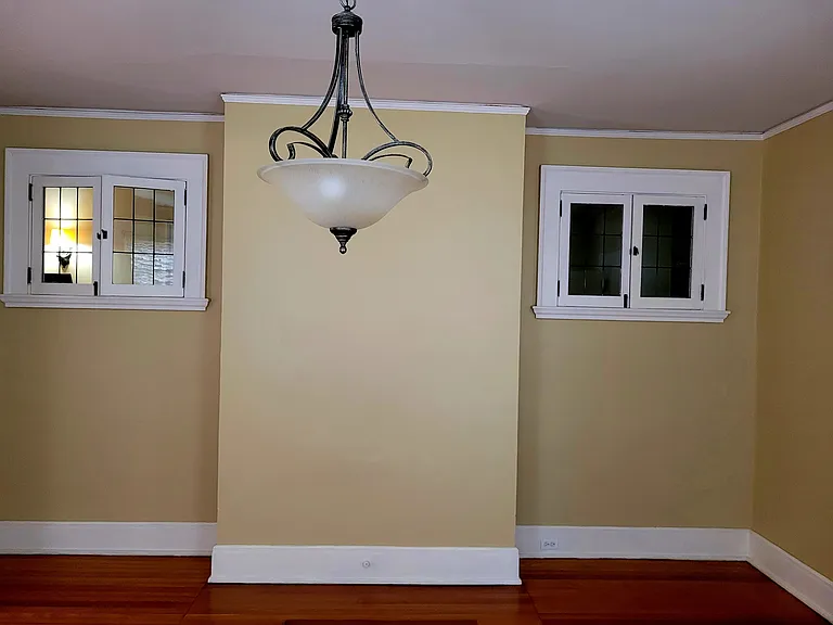 Unique windows in dining room add air and light to the hallway