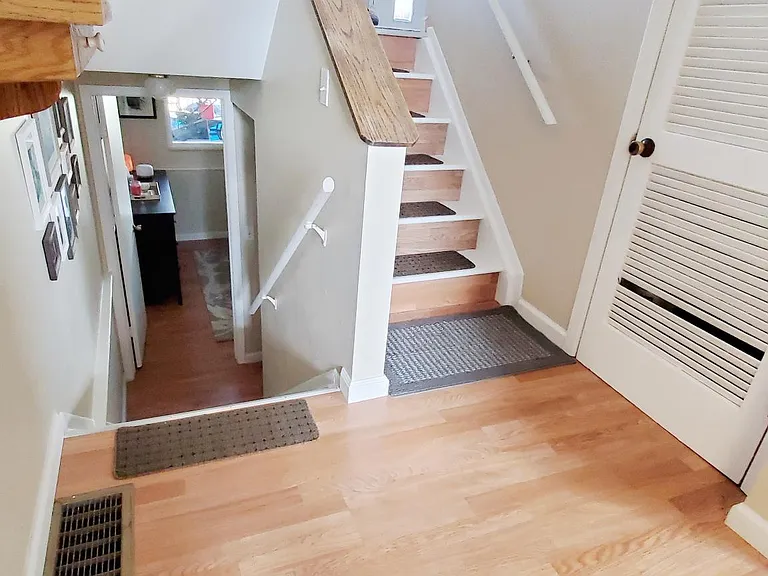 front entry. stairs go up to living room/dining kitchen and down to the master and full bath
