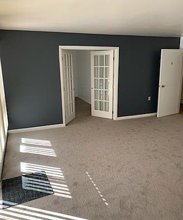 Living room area showing entrance to bedroom suite