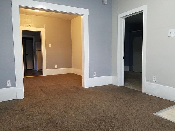 View from family room into dining room/kitchen. Front bedroom through right door.