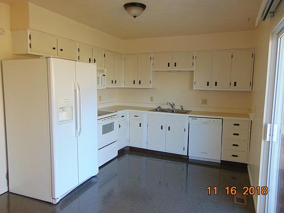 This is the upper level kitchen in this split entry home with electric stove, dishwasher and double sided refrigerator.