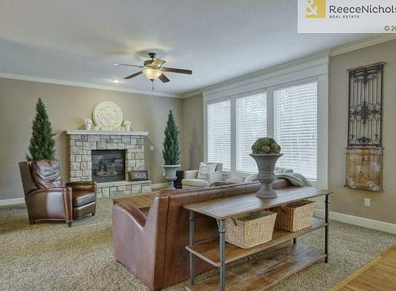 Warm hearth w/focal stone fireplace and serene wooded views