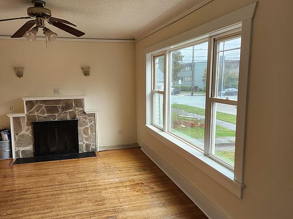 Spacious and bright living room with large picture window.