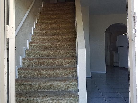 Stairs have carpet to prevent falls with a sturdy handrail.