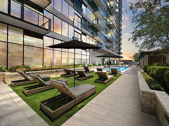 Resort-style pool deck offering both sunny and shaded seating areas