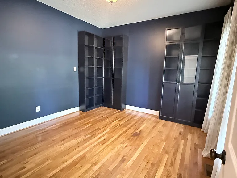 To the righ of the foyer is the office/media room or playroom with built in shelving.