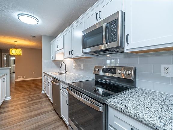 New updated bright kitchen with tile backsplash and granite countertops.