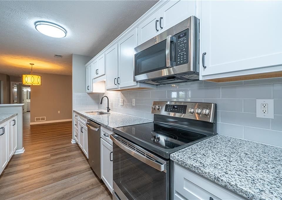 New updated bright kitchen with tile backsplash and granite countertops.