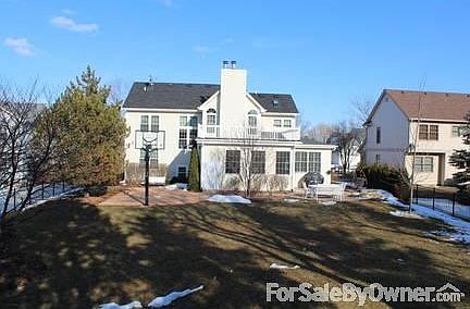 fenced in backyard with brick patio, built-in firepit and basketball court