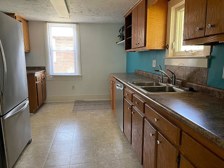 Spacious kitchen for small home with plenty of countertop space and cabinet storage.
