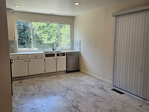 Kitchen, sliding door to side yar covered patio