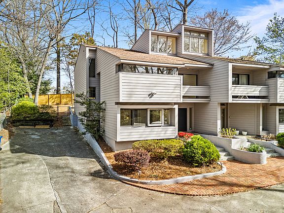 Mid-century modern hilltop home in Buckhead with a private driveway and two dedicated parking spaces right next to the townhome