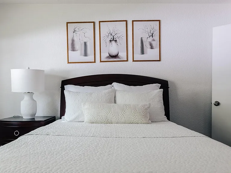Master bedroom features a queen bed and a working space