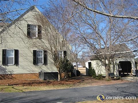 Side of house and view of smokehouse