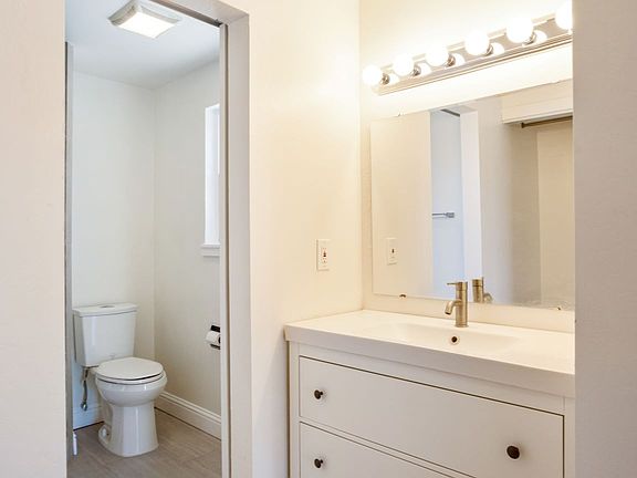 The master bathroom has a single vanity and separate shower stall & toilet room