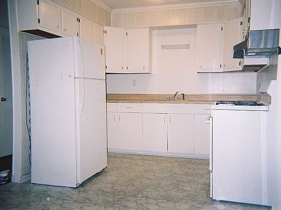 The kitchen conveniently opens into the living room and breakfast areas.