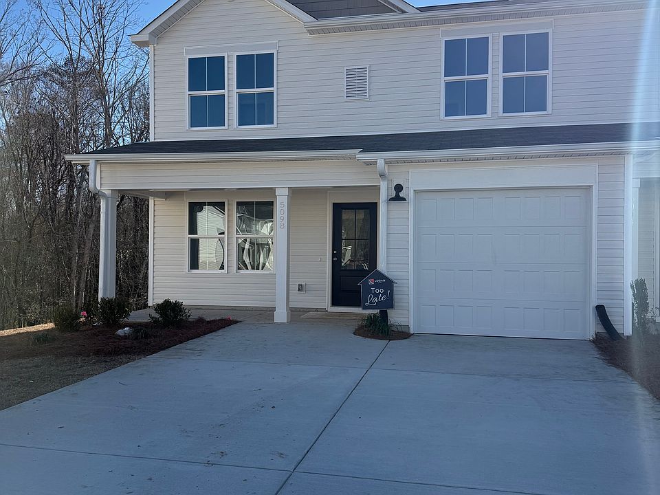 End unit with wooded and water view with off street parking.