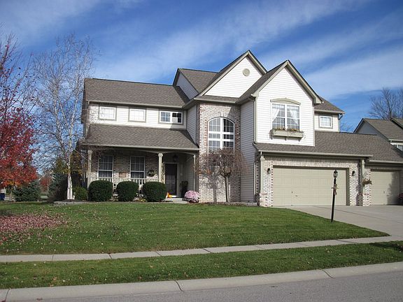 Home has large front porch, 3 car garage, and custom window flower box