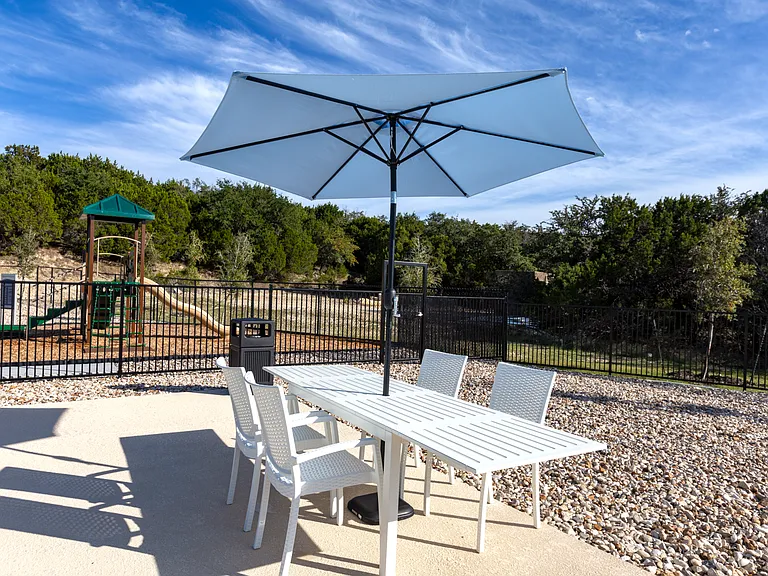 Outdoor seating area with shaded tables.