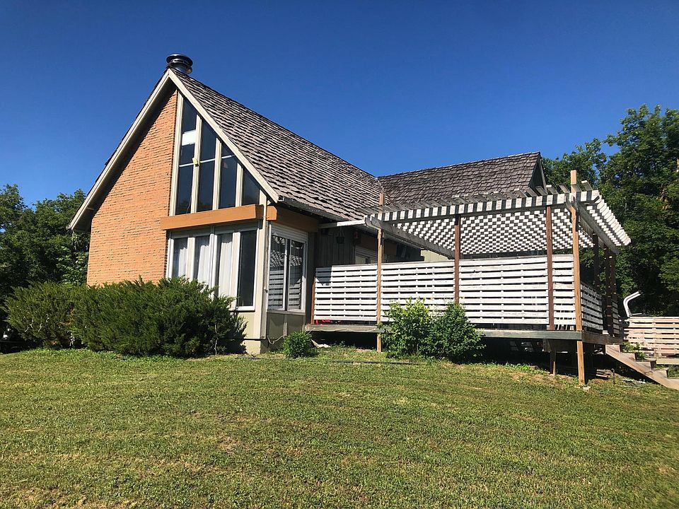 Front side of home, large privacy deck, and pergola.