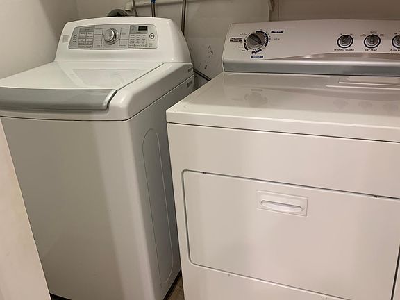 Updated laundry room with plenty of storage shelves brand new flooring and newer washer and dryer