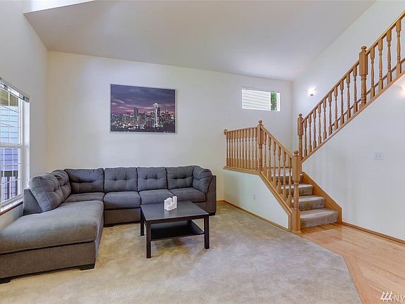 Many windows fill this spacious living room fill the space with ample natural light.