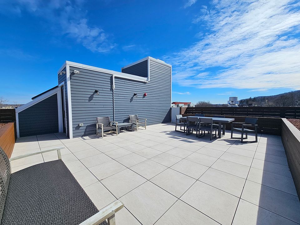 Gorgeous shared rooftop offering expansive open space, stylish seating, and sweeping sky views. Perfect for relaxing, or enjoying fresh air in a peaceful, modern setting.
