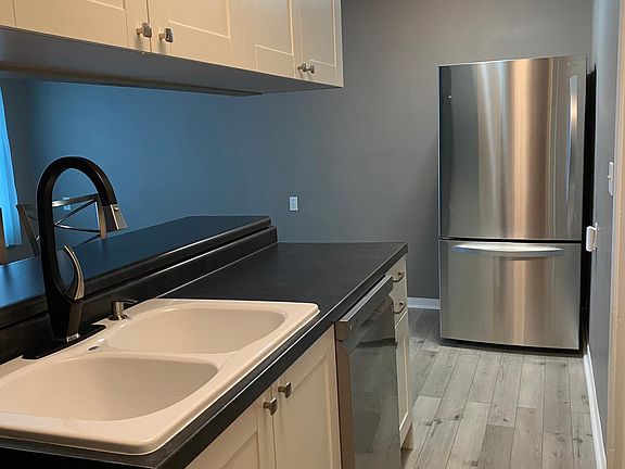 New stainless refrigerator with ice maker and bottom freezer.