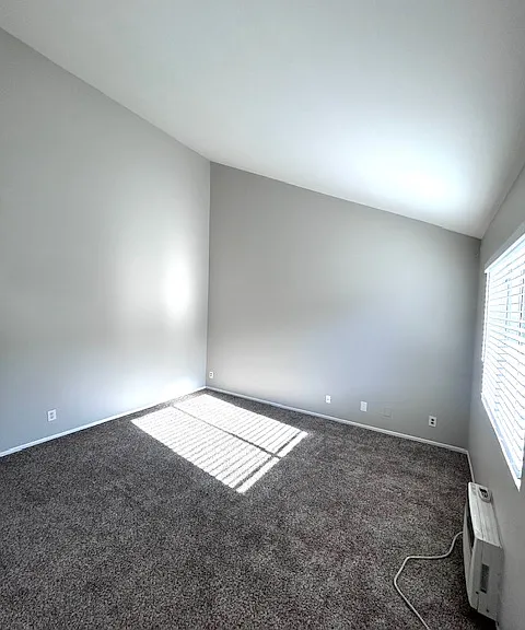 Living Room with vaulted ceilings and in wall A/C unit