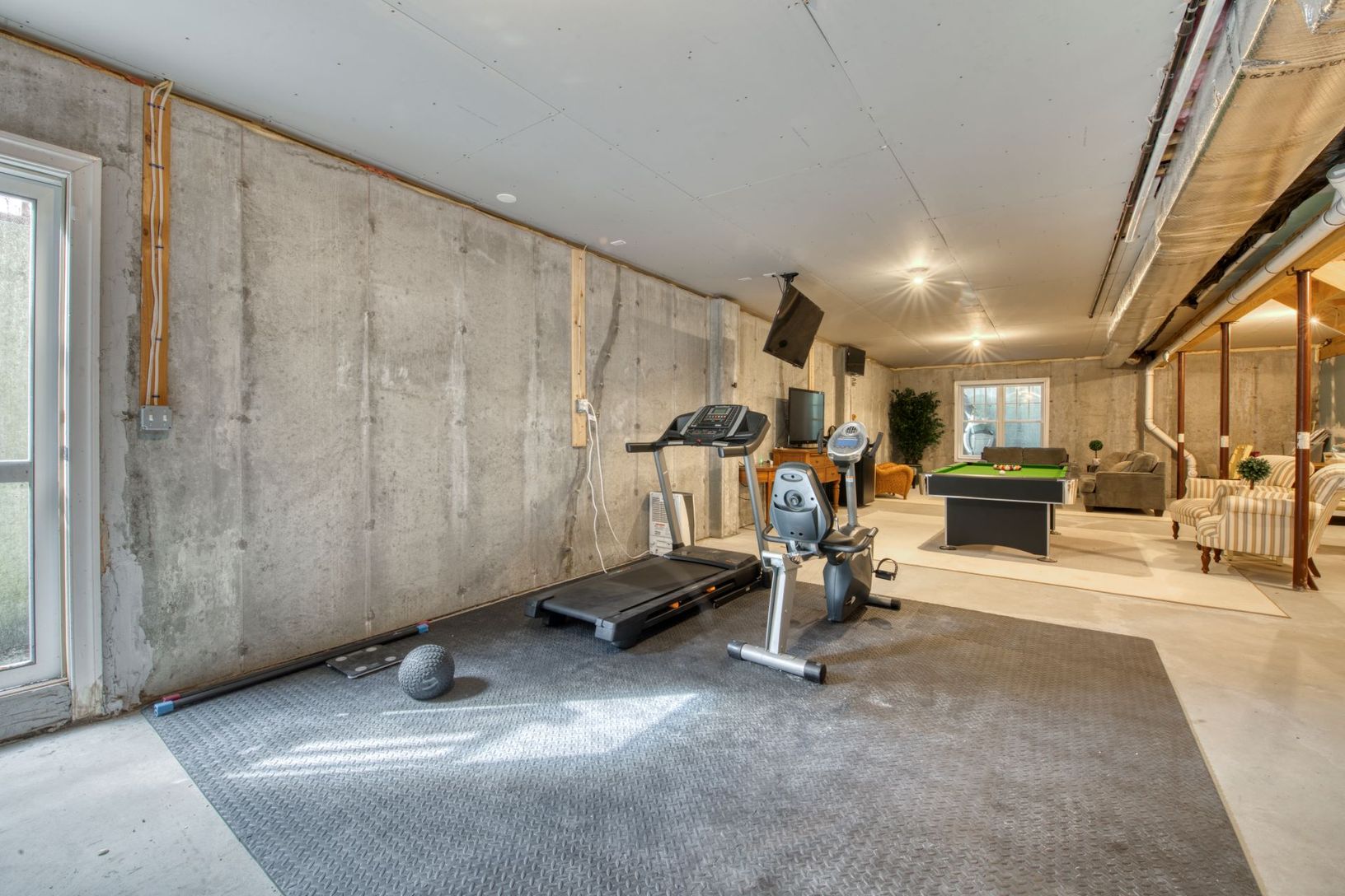  basement with 10ft ceilings, egress window, walk-out door and plumbing in place for custom finishing